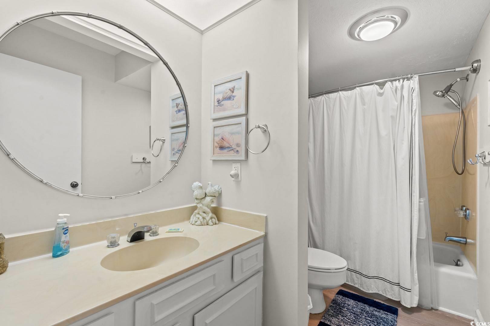 5507 North Ocean Boulevard, Unit 113 Myrtle Beach, SC 29577 - Photo 13 of 28 Full bathroom featuring shower / tub combo, vanity, and light wood-style flooring