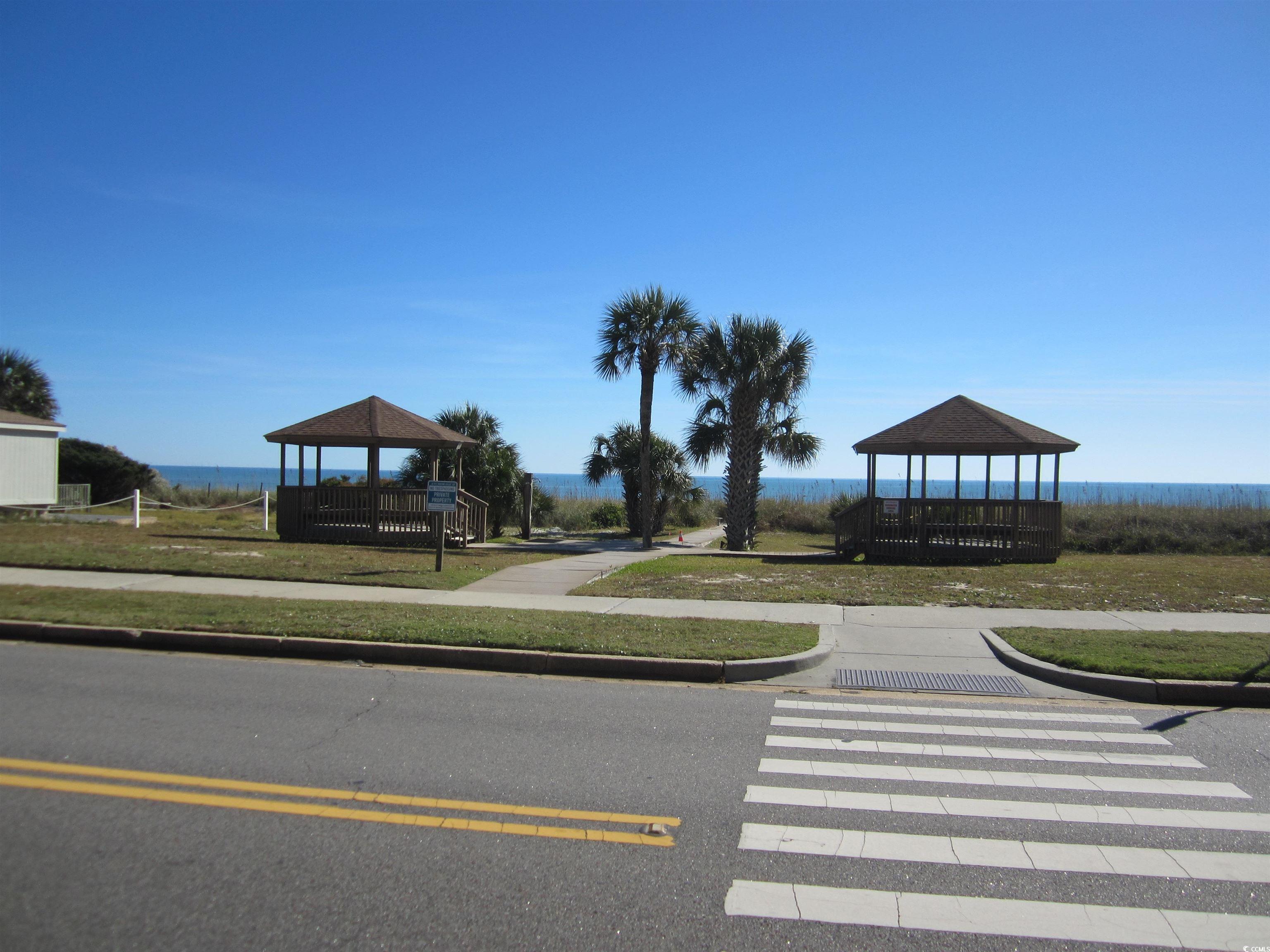 5507 North Ocean Boulevard, Unit 113 Myrtle Beach, SC 29577 - Photo 18 of 28 View of property's community with a gazebo and a water view