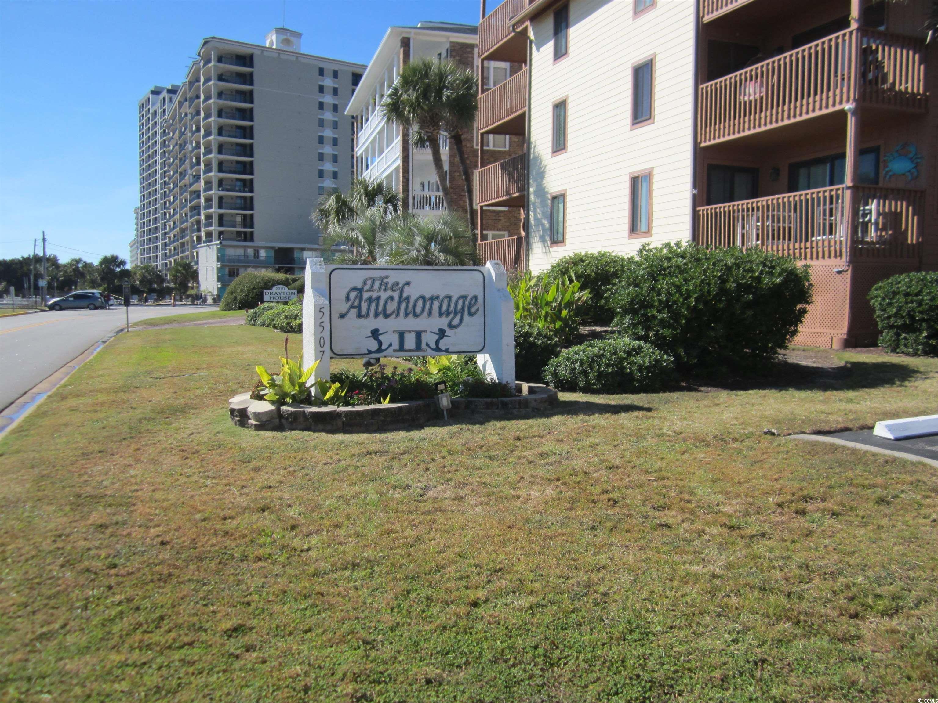 5507 North Ocean Boulevard, Unit 113 Myrtle Beach, SC 29577 - Photo 19 of 28 Community sign with a yard