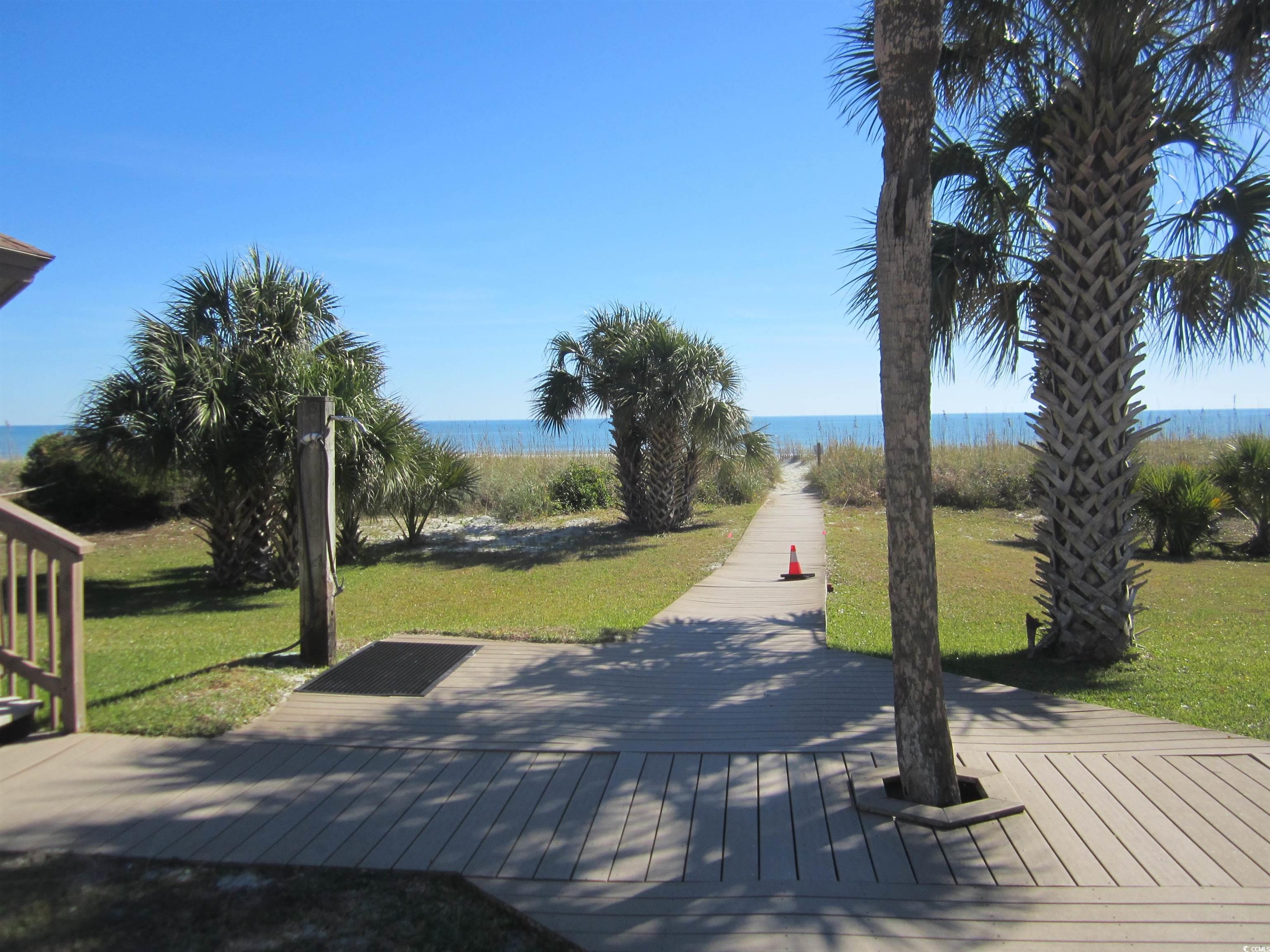 5507 North Ocean Boulevard, Unit 113 Myrtle Beach, SC 29577 - Photo 21 of 28 View of property's community featuring a yard and view of water and beach