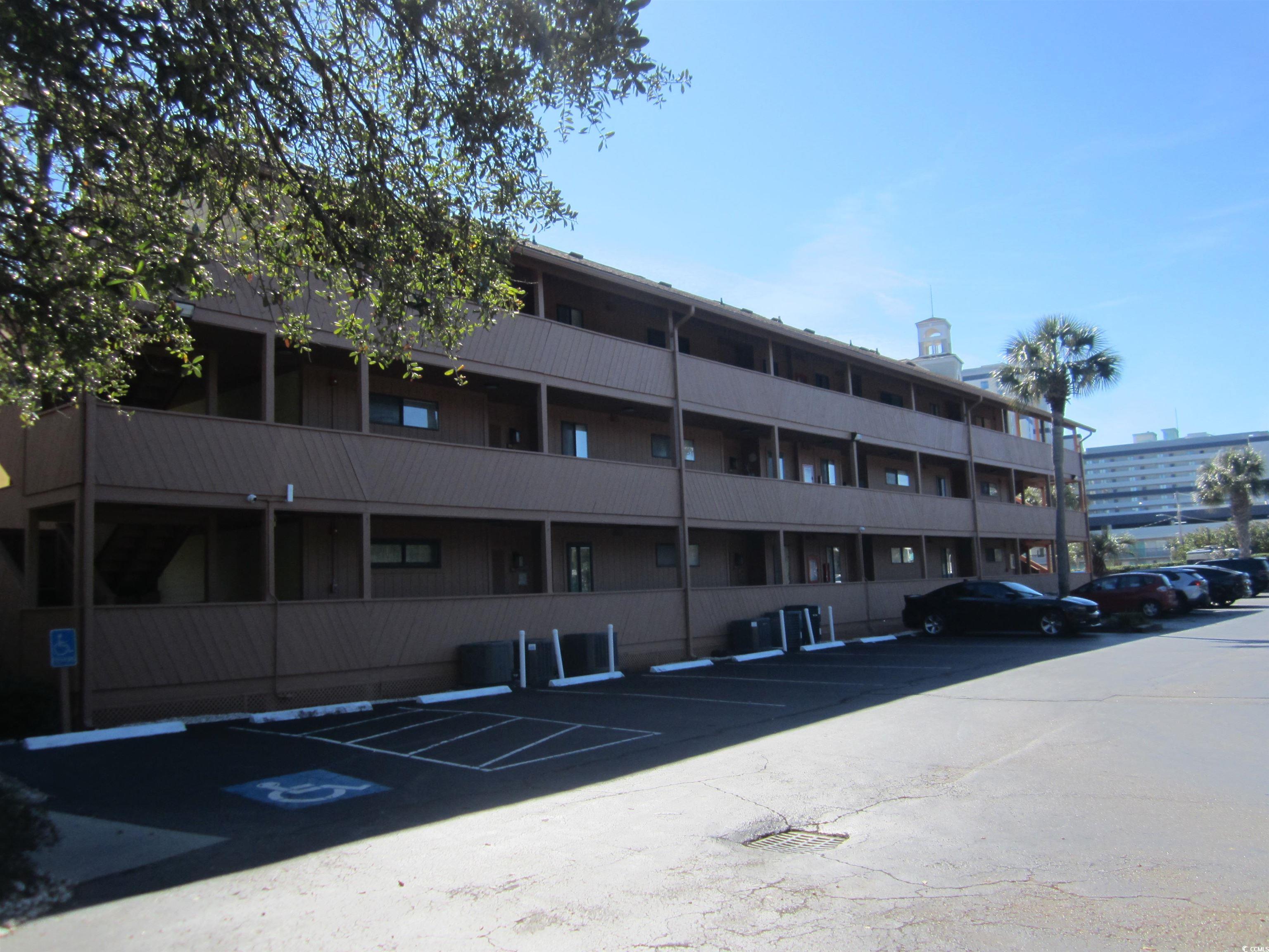 5507 North Ocean Boulevard, Unit 113 Myrtle Beach, SC 29577 - Photo 27 of 28 View of apartment building / complex with uncovered parking