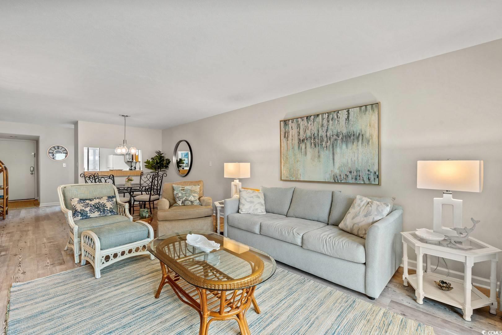 5507 North Ocean Boulevard, Unit 113 Myrtle Beach, SC 29577 - Photo 3 of 28 Living area featuring light wood-style flooring and a chandelier