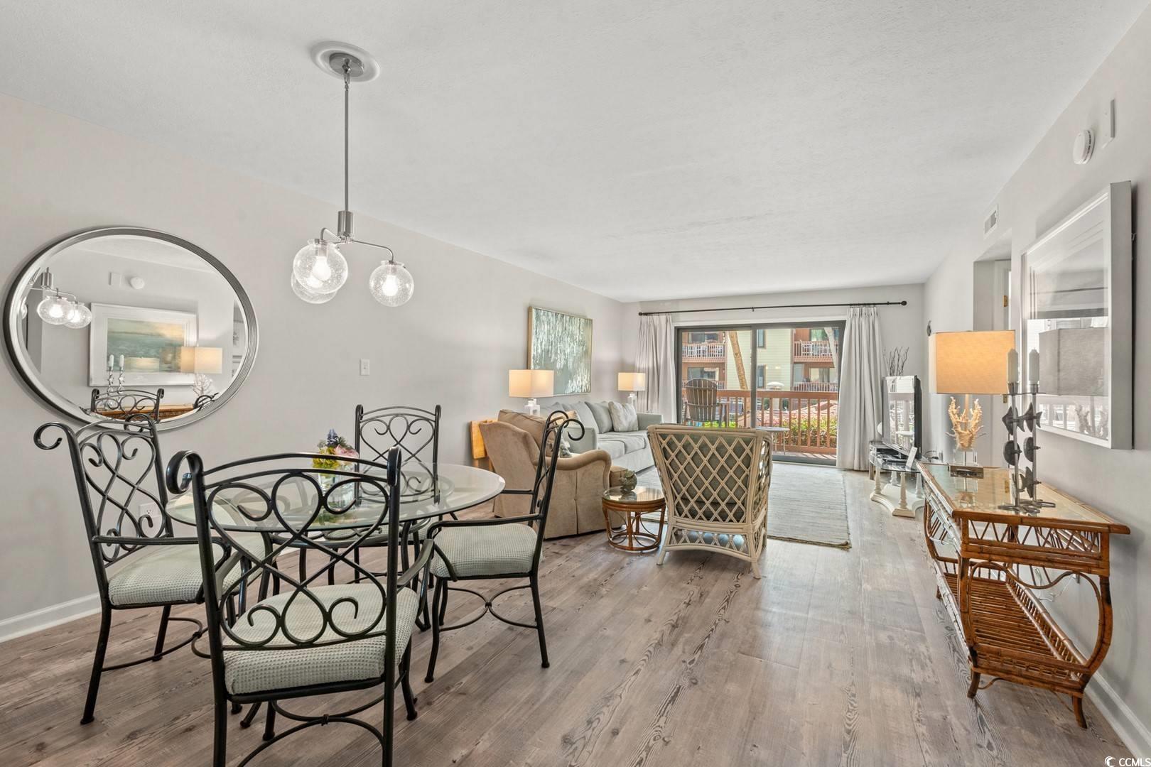 5507 North Ocean Boulevard, Unit 113 Myrtle Beach, SC 29577 - Photo 5 of 28 Dining room with baseboards and wood finished floors
