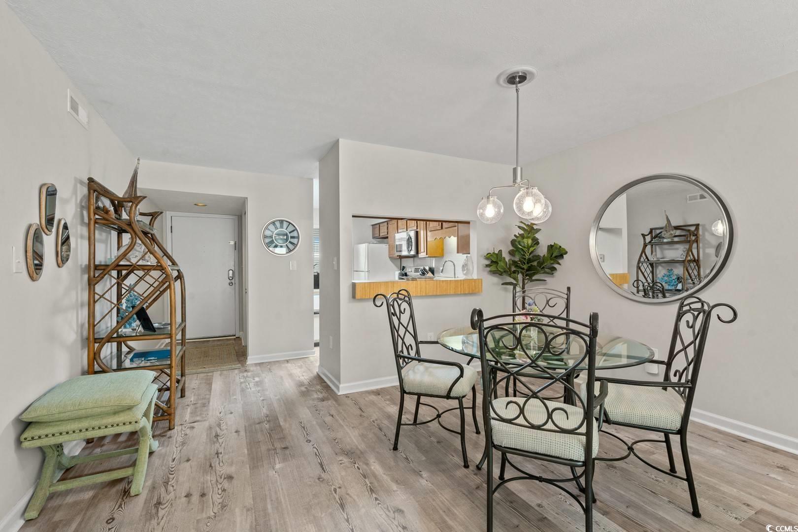 5507 North Ocean Boulevard, Unit 113 Myrtle Beach, SC 29577 - Photo 6 of 28 Dining area with wood finished floors and baseboards
