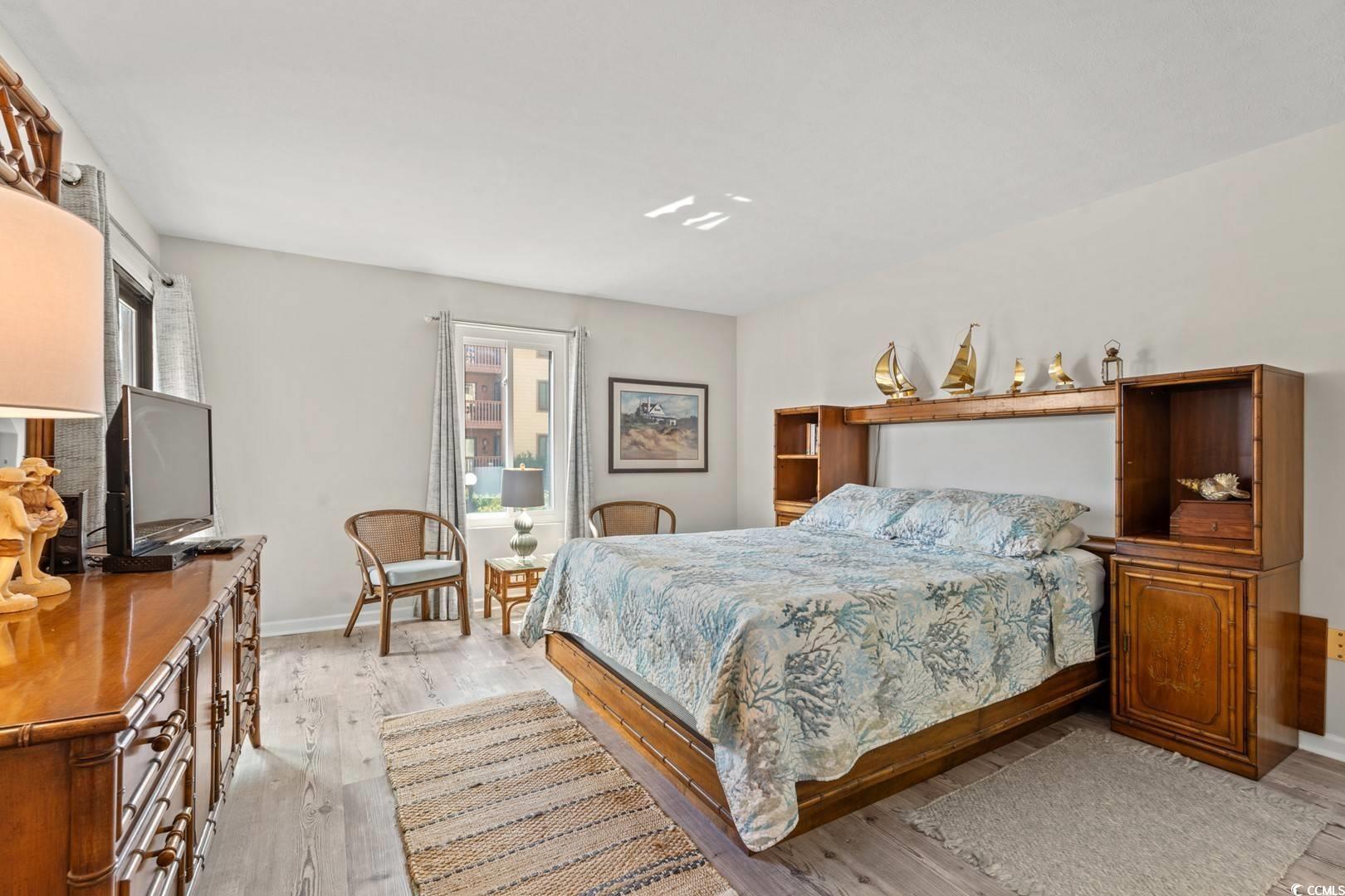 5507 North Ocean Boulevard, Unit 113 Myrtle Beach, SC 29577 - Photo 9 of 28 Bedroom featuring light wood-style floors and baseboards