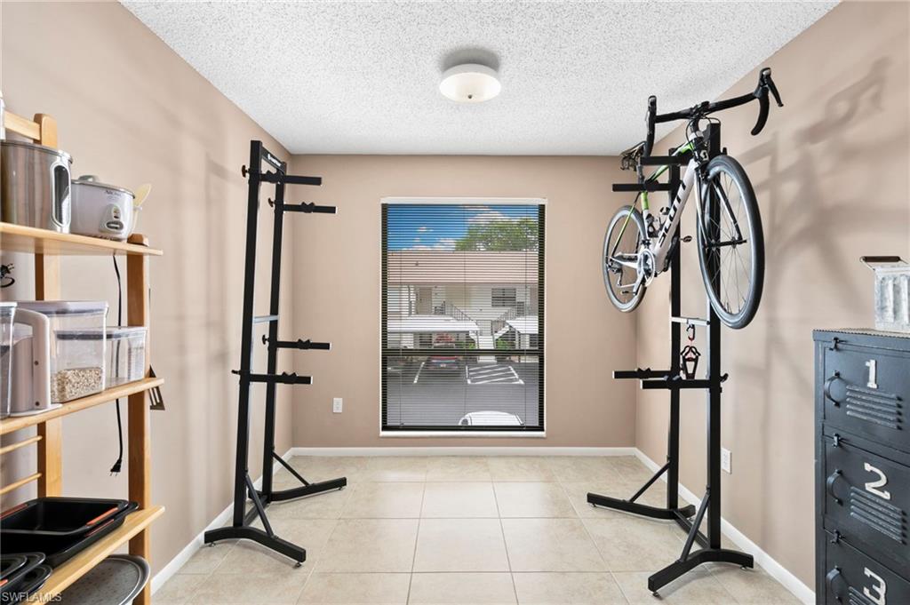 236 Pebble Beach Circle, Unit A202 Naples, FL 34113 - Photo 11 of 25 a view of a room with gym equipment