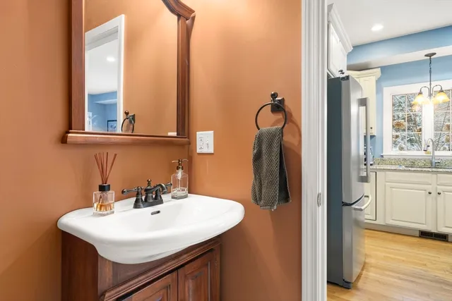 a bathroom with a sink a mirror and a window