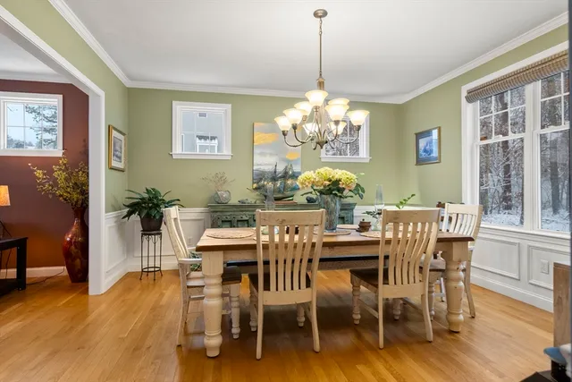 a view of a dining room with furniture wooden floor and chandelier