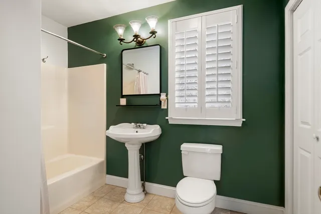 a bathroom with a sink a toilet and bathtub