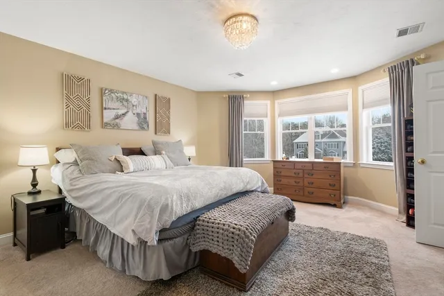 a spacious bedroom with a large bed and a large window