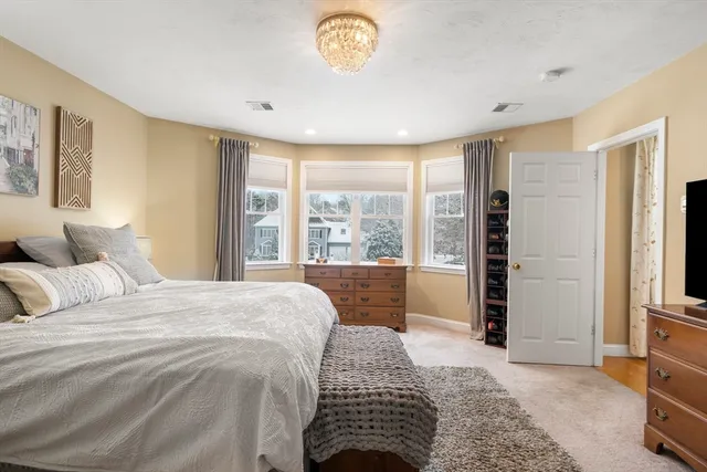 a bedroom with a bed and a large window