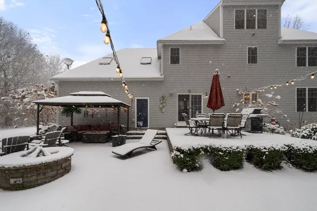 a view of a patio with table and chairs under an umbrella