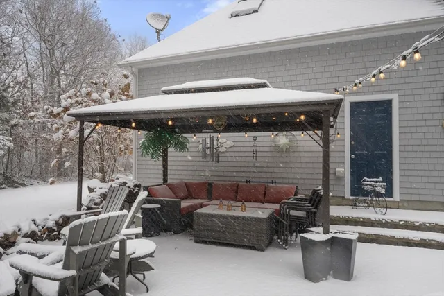 a couple of blue chairs sitting in patio of a house