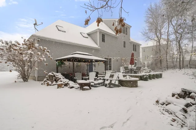 a view of a white house with a snow on the road