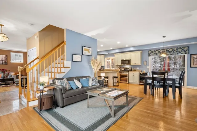 a living room with lots of furniture and wooden floor