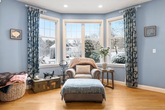 a bedroom with furniture and a large window