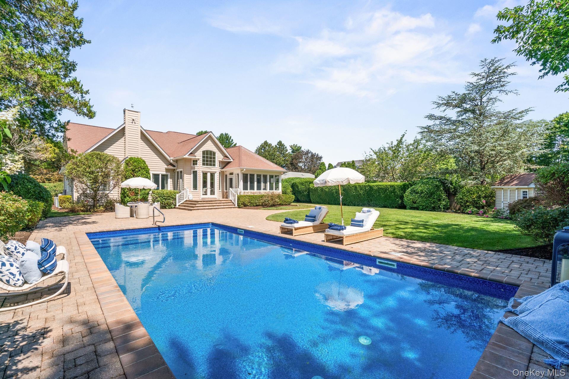a front view of house with yard swimming pool and green space
