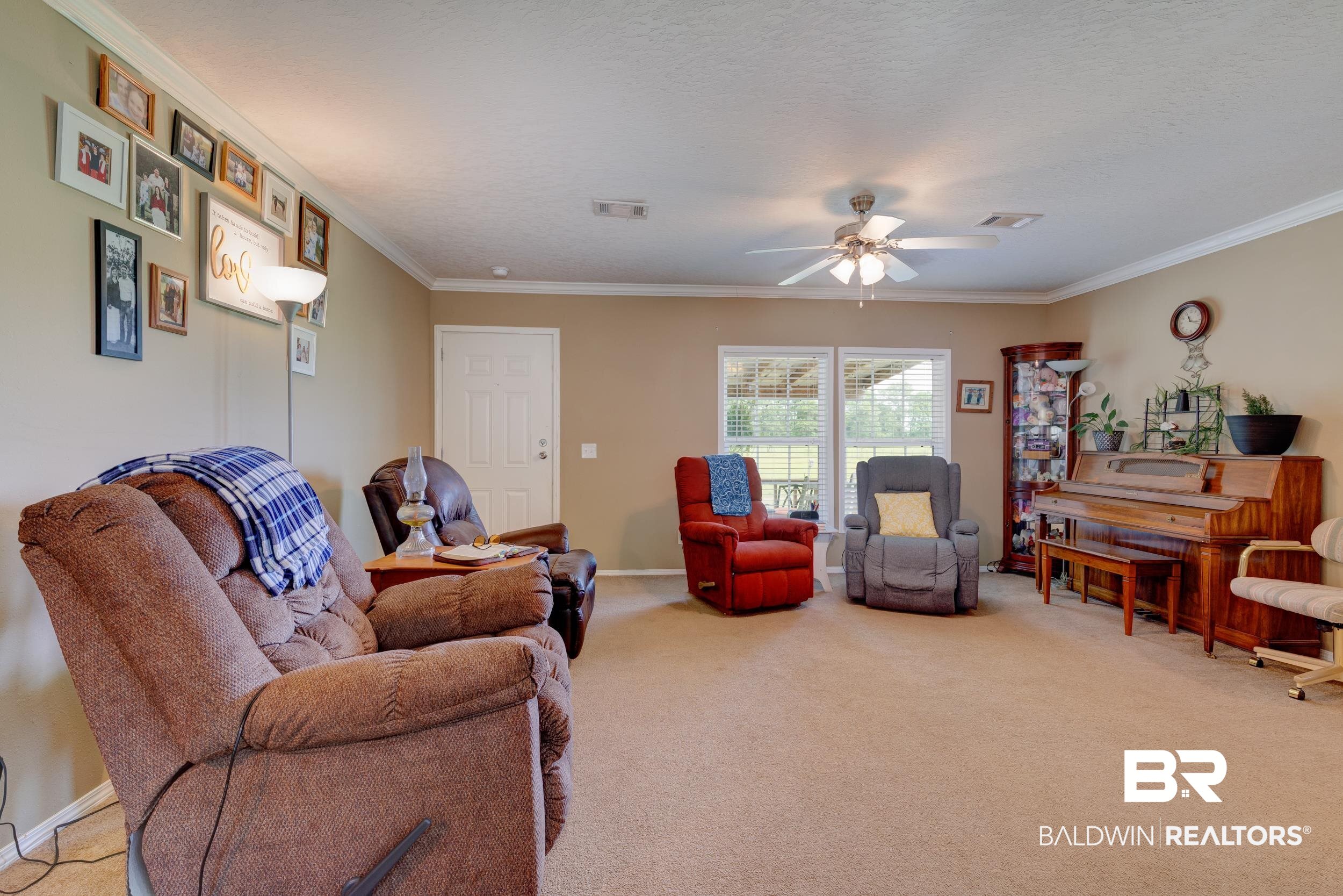 6725 Upper Creek Road Flomaton, AL 36441 - Photo 33 of 61 Carpeted living room featuring ornamental molding, a ceiling fan, and baseboards
