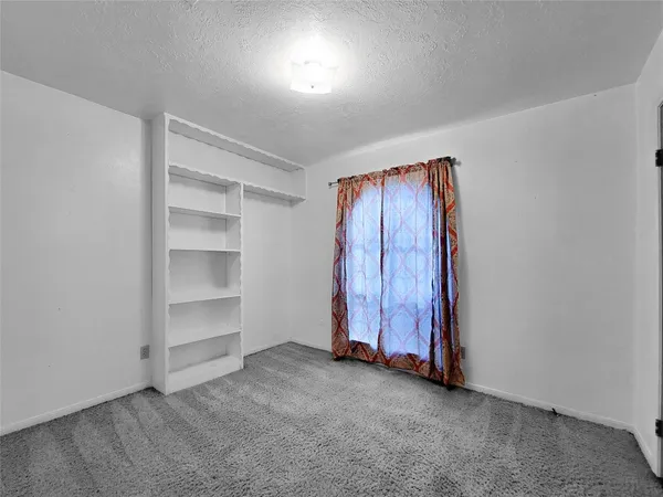 a view of an empty room with a fireplace