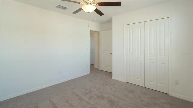 a view of an empty room with a fan