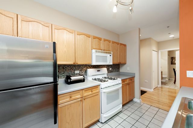 a kitchen with stainless steel appliances a refrigerator sink and cabinets