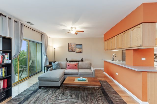a living room with furniture and a book shelf