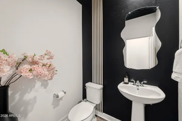 a bathroom with a sink mirror and toilet