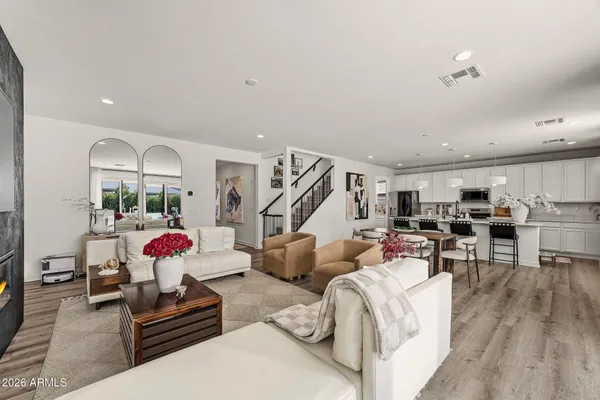 a living room with furniture and a wooden floor