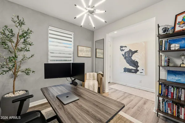 a view of entryway with workspace and wooden floor