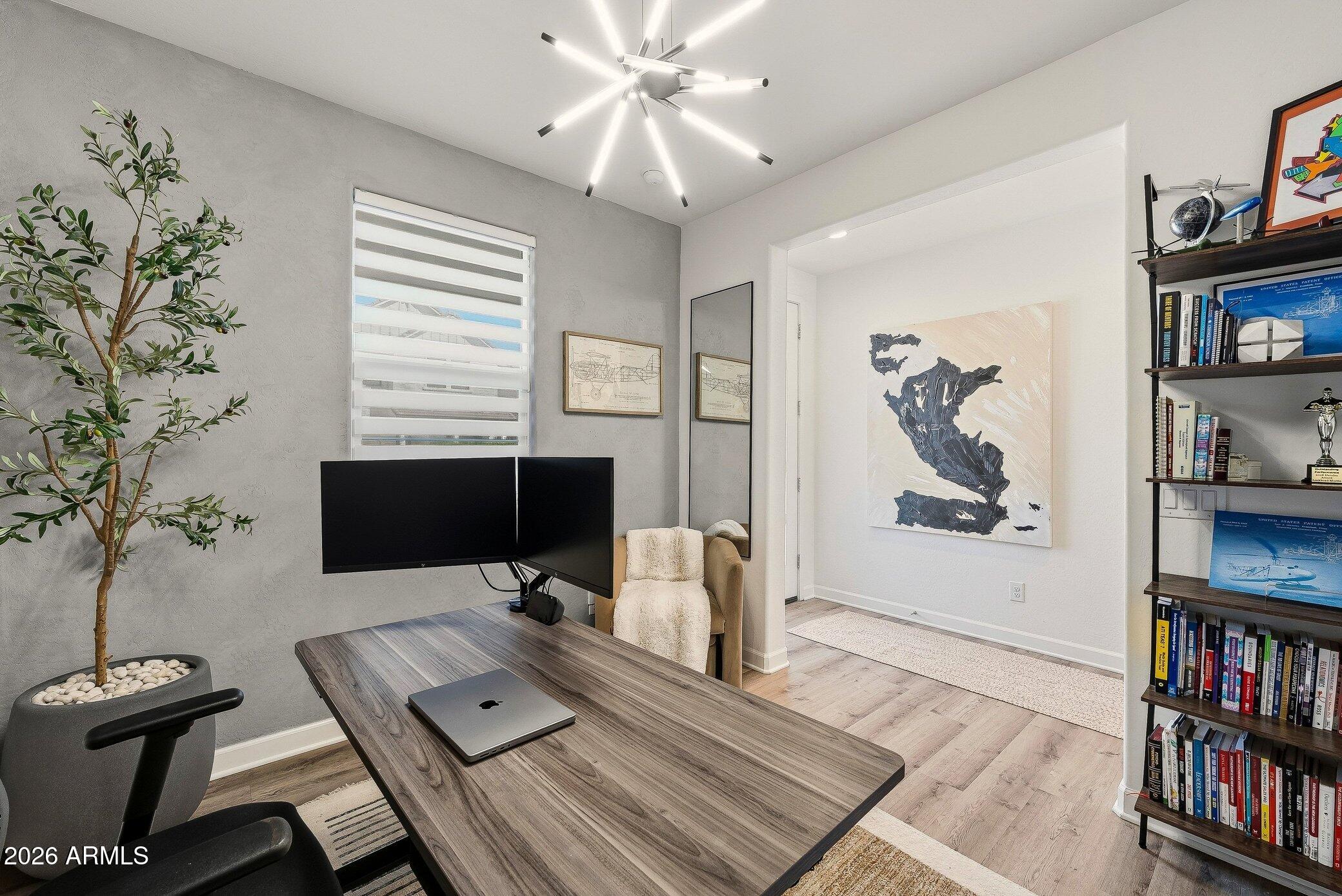 35032 North Barrel Road Queen Creek, AZ 85144 - Photo 12 of 40 a view of a workspace with furniture and a book shelf