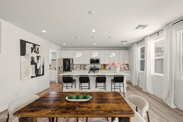 a view of a dining room with furniture window and wooden floor