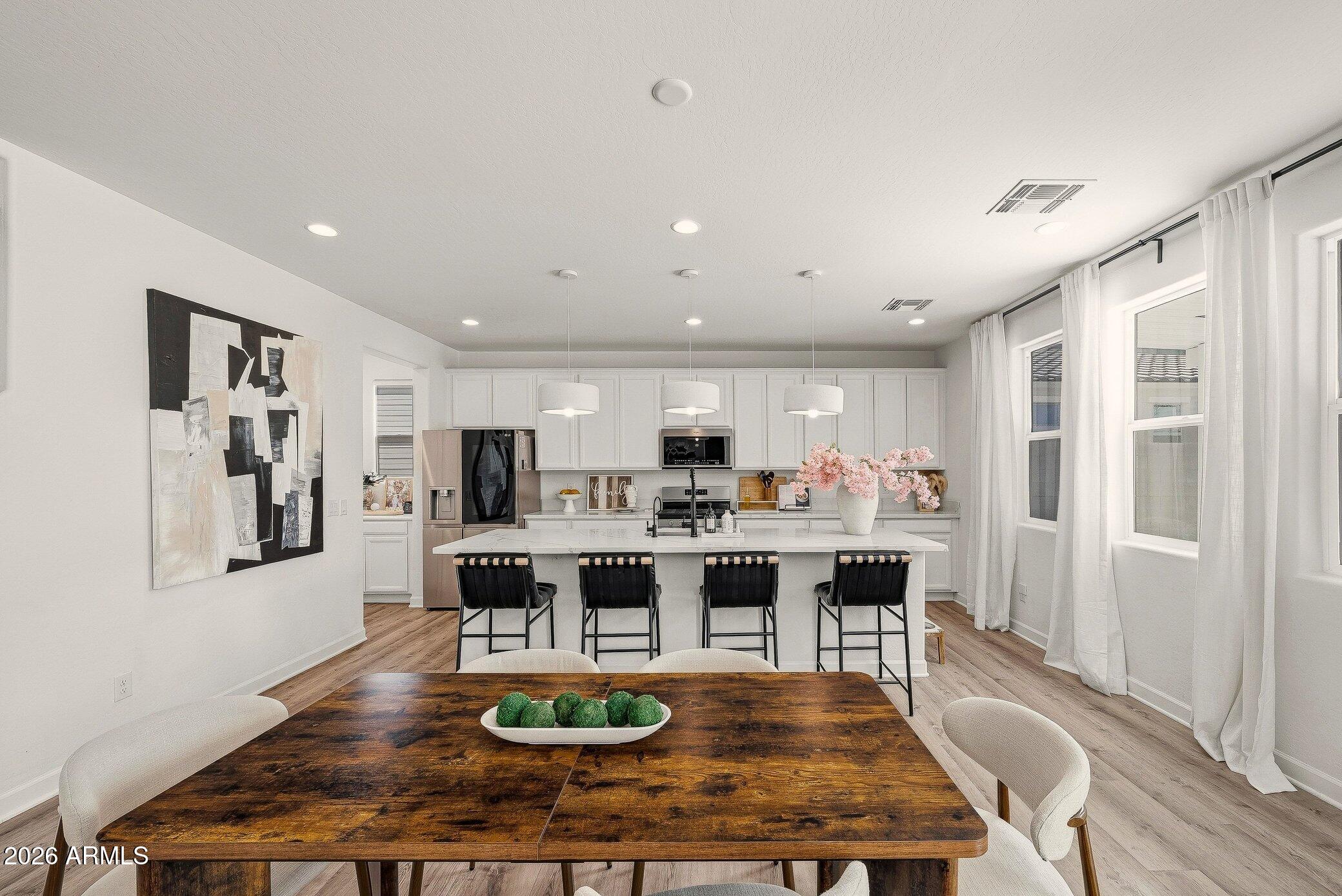 35032 North Barrel Road Queen Creek, AZ 85144 - Photo 17 of 40 a view of a dining room with furniture window and wooden floor