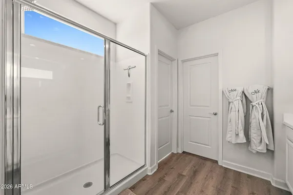 a view of walk in closet with clothes and shoes