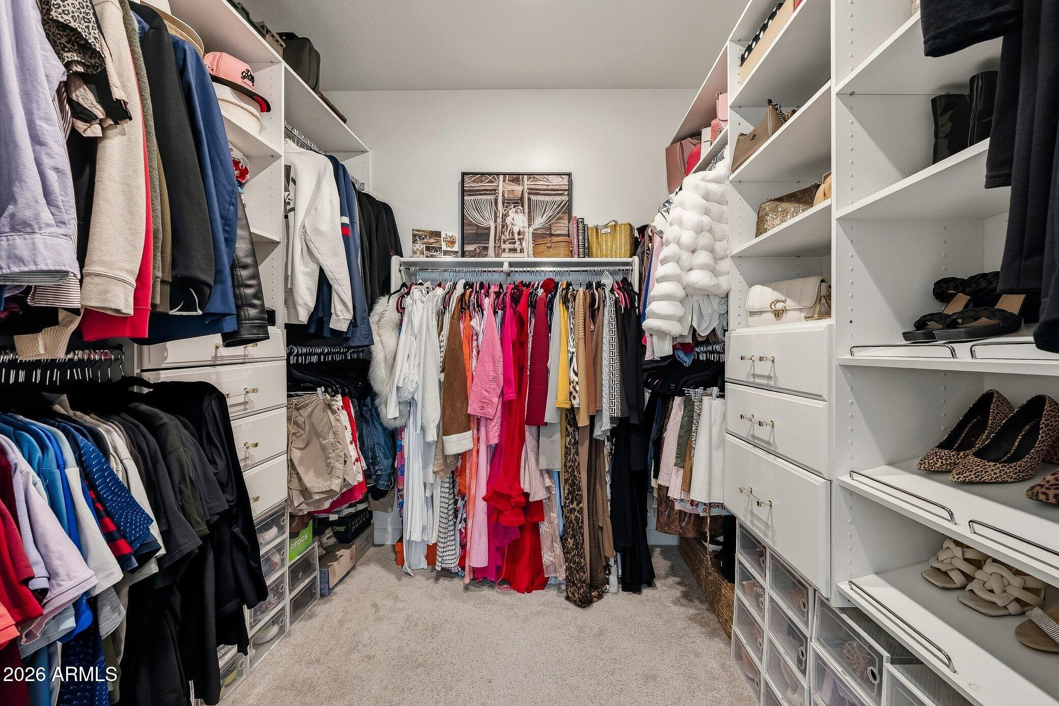 35032 North Barrel Road Queen Creek, AZ 85144 - Photo 29 of 37 a view of walk in closet with clothes and shoes