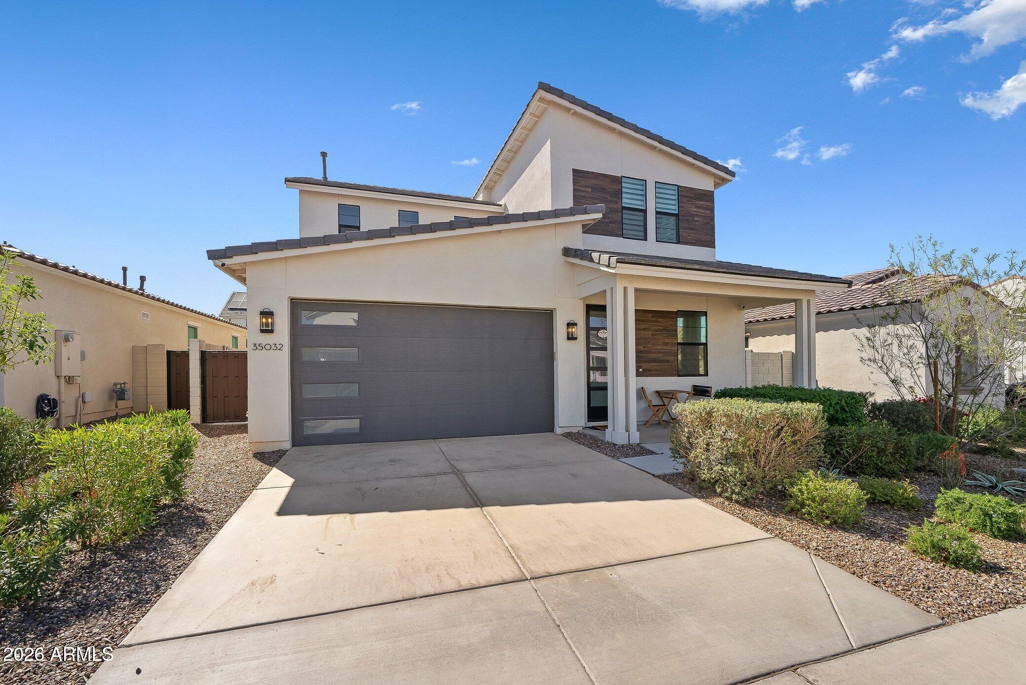 35032 North Barrel Road Queen Creek, AZ 85144 - Photo 2 of 40 a front view of a house with a garden