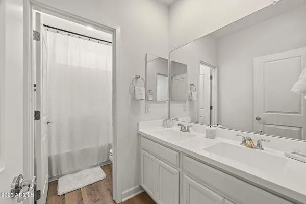 a bedroom with a bed and with a white cabinet