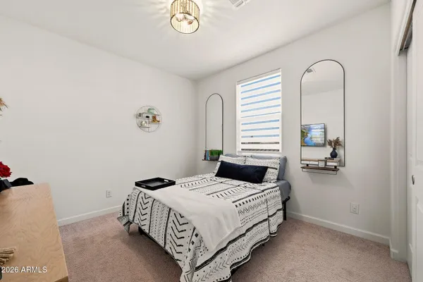 a bedroom with a bed and a dresser