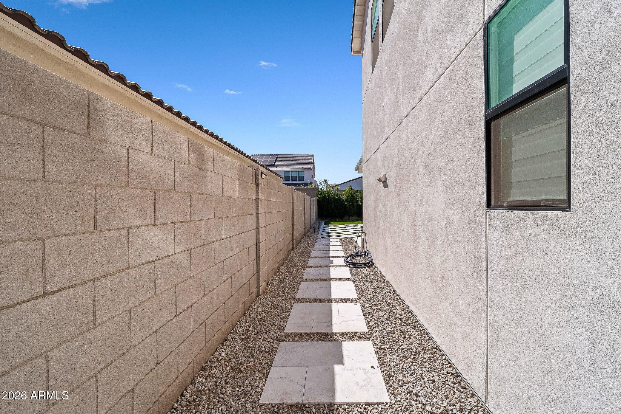 35032 North Barrel Road Queen Creek, AZ 85144 - Photo 9 of 37 a view of a pathway with a white house