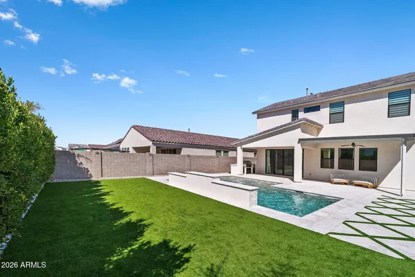 a view of a swimming pool with a yard