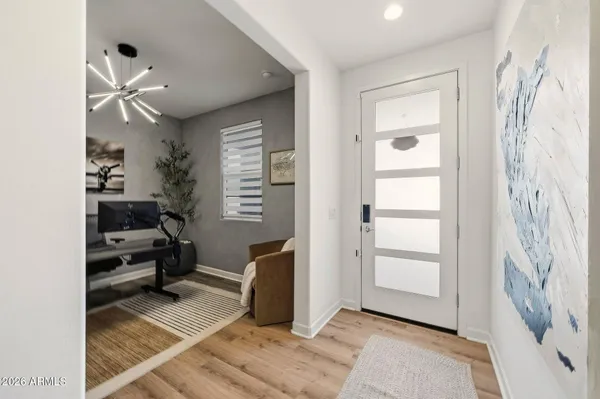 a view of entryway with workspace and windows