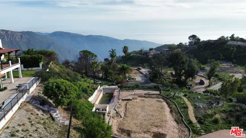 an aerial view of a house with mountain view