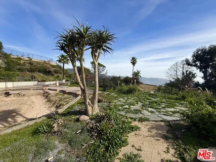 a view of a street with houses on the side of the road