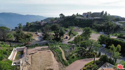 an aerial view of a house with mountain view