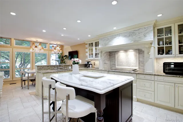 a kitchen with granite countertop a table chairs sink and wooden floor