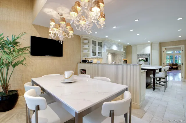 a view of a dining room with furniture and a flat screen tv