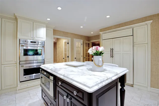 a kitchen with stainless steel appliances granite countertop a kitchen island and cabinets