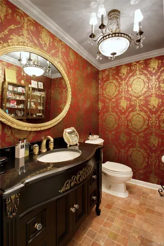 a bathroom with a sink mirror vanity and toilet