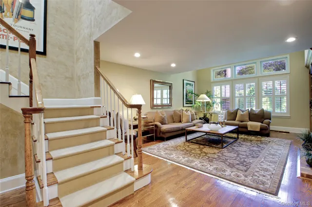 a living room with furniture wooden floor and a rug