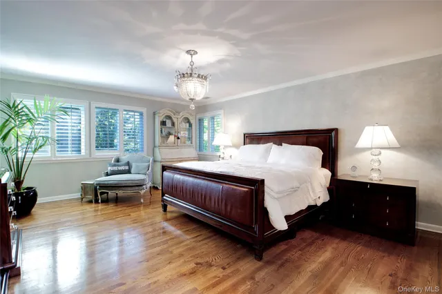 a spacious bedroom with a bed and wooden floor