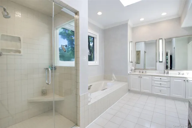 a bathroom with a granite countertop tub sink shower and mirror